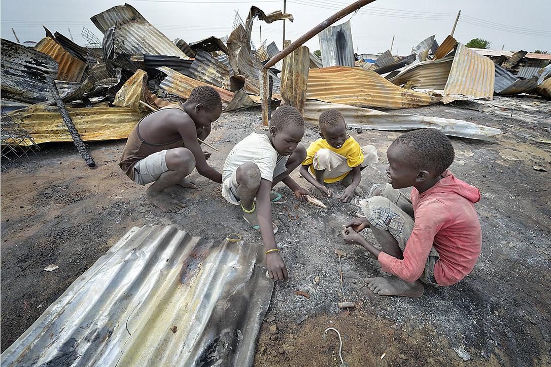 Children look for valuable items in the ashes of what was once the central market in Bor. Photo: Paul Jeffrey/ACT Alliance
