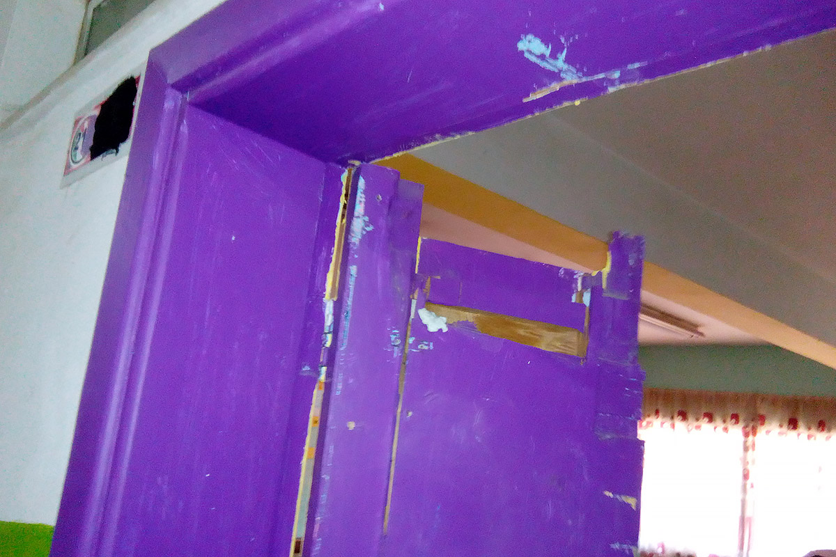  A broken door to a classroom before the school was rehabilitated.