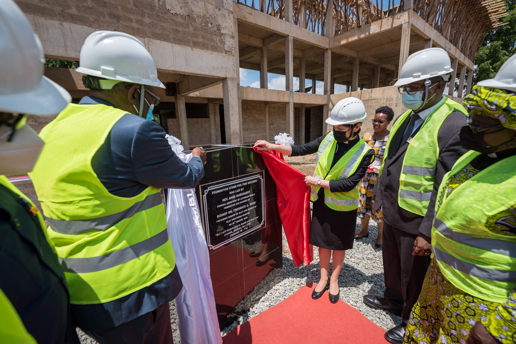 ELCT Presiding Bishop Dr Fredrick Shoo (left) and LWF General Secretary Rev. Anne Burghardt (right) unveil a foundational stone at a construction site for what is to become a hostel for cancer patients to the Kilimanjaro Christian Medical Centre of the ELCT.