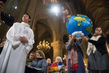 Youth hold symbols of creation during an ecumenical celebration at the Cathredral of Notre Dame de Paris during the COP 21 climate talks taking place in nearby Le Bourget, 3 December 2015 Photo: LWF/Ryan Rodrick Beiler