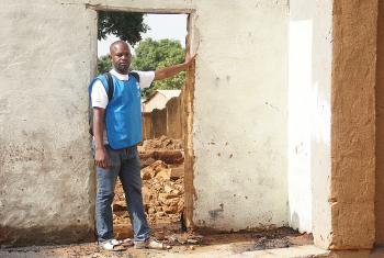 Armand Yabinti, community outreach officer for the LWF emergency program in CAR, outside the ruins of his house in Bohong village, Ouham Pendé prefecture.  Photo: LWF/P. Mumia
