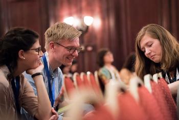 Paula Göhre (left) and Tim Sonnemeyer of the Evangelical Lutheran Church in Bavaria welcome their synod's decision to strengthen youth participation. Here they meet with Rebecca Lühmann of the Evangelical Lutheran Church of Hanover at the LWF Twelfth Assembly. Photo: LWF/Albin Hillert