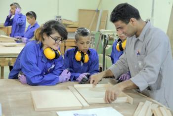 Students watch as a teacher demonstrates a technique in the carpentry workshop. The summer camp encouraged girls and boys to also explore career choices beyond those stereotypically assigned to their gender. Photo: LWF Jerusalem