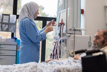 Practical Nurse Muyassar Ismail tends to Dialysis patient Amilio Alvi at Augusta Victoria Hospital. Photo: LWF/Albin Hillert