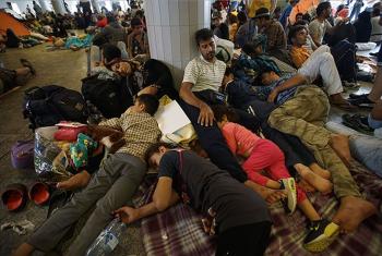 Refugees lie exhausted in a public place in Hungary, en route to northern European countries. Photo:MTI