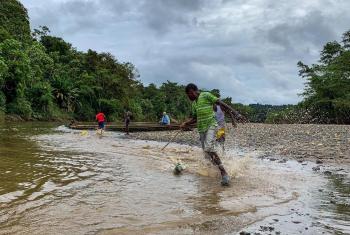 Youth playing on the banks of Río Pogue in Atrato, northwestern Colombia. The LWF supports local communities to uphold their rights and protect the Atrato River, which has been polluted by material from extractive industries for decades. Photo: LWF/G. A. Moreno Clavijo