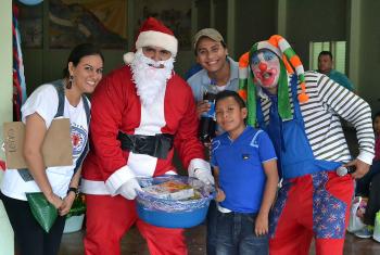 AIDS work in the Nicaraguan Lutheran Church of Faith and Hope prioritizes children. Rev. Soliette López, left, Alexander García, Kevin Mena and Sergio Rios take part in a children's Christmas party for children often  left out because of discrimination, in the western city of Masaya, near the capital Managua. Photo: Daniela Cruz