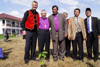 (From left) LWF General Secretary Martin Junge, LWF President Bishop Dr Munib Younan, LWF National Committee in Indonesia Chairperson Bishop Langsung Sitorus and other member church representatives with a Luther Garden partner tree planted at the Ecumenical Center of the Council of Protestant Indonesian Churches in North Sumatra on 15 June 2014. Photo: LWF/C. Kästner