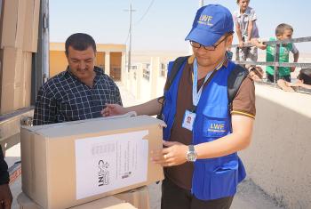 LWF assisting in the distribution of winter clothes sponsored by the Evangelical Lutheran Church of Bavaria in Khanki camp, Northern Iraq. Photo: LWF Iraq
