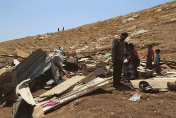 People pick through rubble at the site of a demolition in Wadi Sneysel, in the West Bank near East Jerusalem.