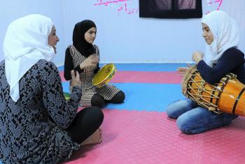 An instructor teaches the capoeira drum beat to young women in the peace oasis. All photos: LWF/ E. Massel