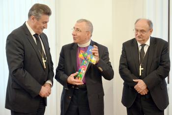 Bishops Ernisa and Filo from Slovenia presented with gift from Bishop Younan (center) at reception in Lutheran Church Ljubljana. Photo: LWF/H. Martinussen