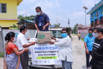 NELC President Rev. Joseph Soren (right) presents packages of medical items and hygiene kits to leaders of Jahada Rural Municipality in Morang district, eastern Nepal. Photo: LCWS/Suman Rai