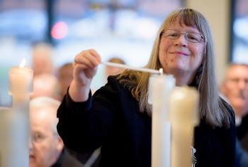 Rev. Jessica Crist, bishop of the Montana Synod of the Evangelical Lutheran Church in America, lights one of the candles for the ecumenical imperatives. Photo: C. Jason Brown/Insight Images