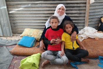 Salam (left, in red T-Shirt) with her grandmother and younger sister in their shelter in Za’atari camp. Photo: LWF Jordan/D. Odén