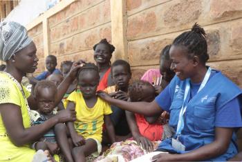Sarah Ewoi, with a South Sudanese refugee family at Nadapal center. Photo : LWF Kenya