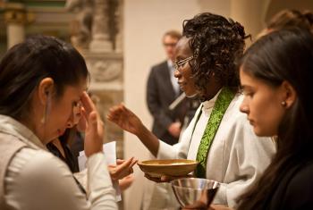 Namibian Lutheran pastor Rev. Lyauvika Nashuuta distributes the sacrament at the closing worship of the 2015 international Global Young Reformers’ Network workshop in Wittenberg, Germany. Photo: LWF/Marko Schoeneberg