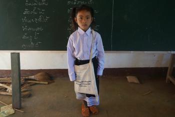 Chanset, an ethnic Khmu girl in northern Laos, with school uniform, books and other items provided by LWF as part of a program to provide access to quality education for girls. Photo: LWF/P. Simayvanh