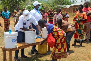 Hand washing before a distribution in Burundi. Water is essential to proper hygiene and to prevent the spread of COVID-19. Photo: LWF Burundi