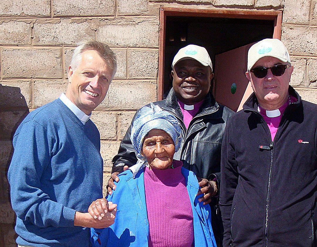 Rev. Martin Junge, Presiding Bishop Dr Alex G. Malasusa and Bishop Dr Frank O. July visit a parishioner in southern Namibia. Photo: LWF/Klaus Rieth