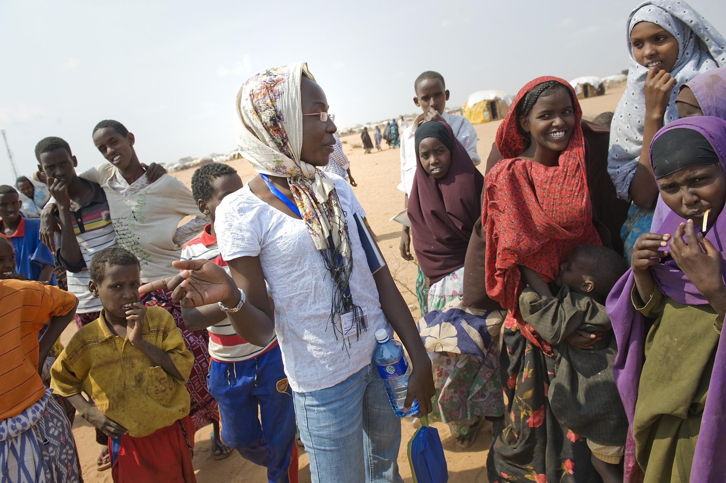 LWF worker Leah Odongo speaks with women in Dadaab refugee camp. Photo: LWF/Jonathan Ernst