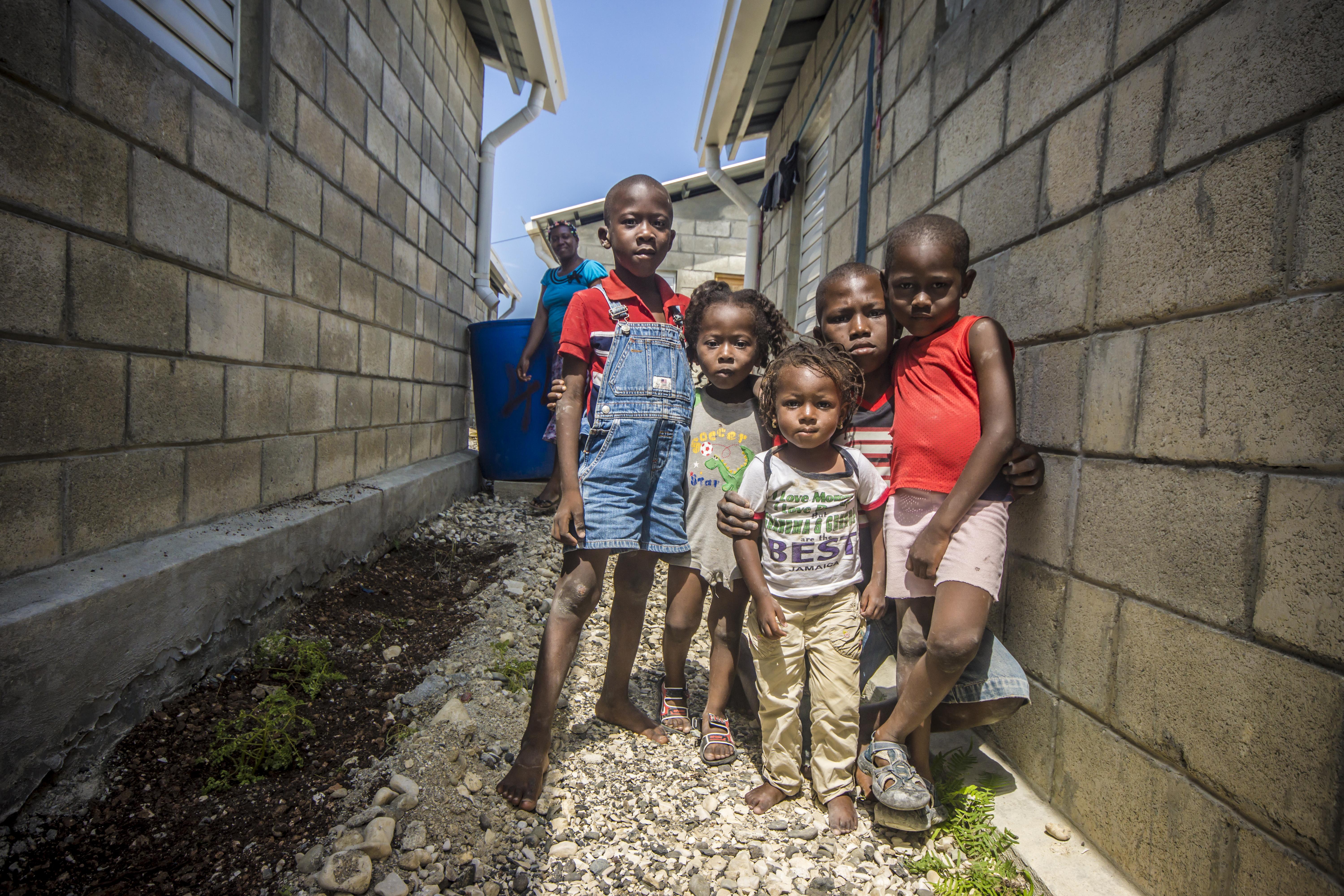 Tiny survivors of the 2010 Haitian earthquake gather outside the Model Resettlement Village in Gressier  