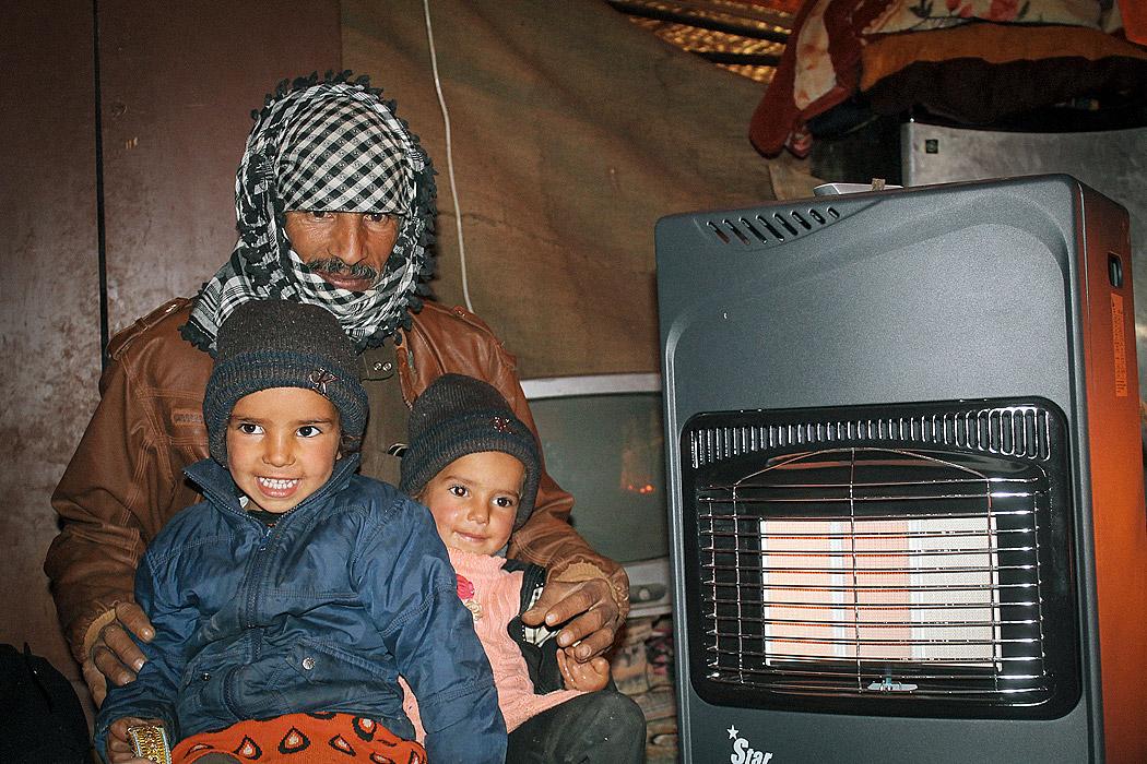 Mohammad and his two daughters in their tent. Photo: LWF/Julia Tarpy