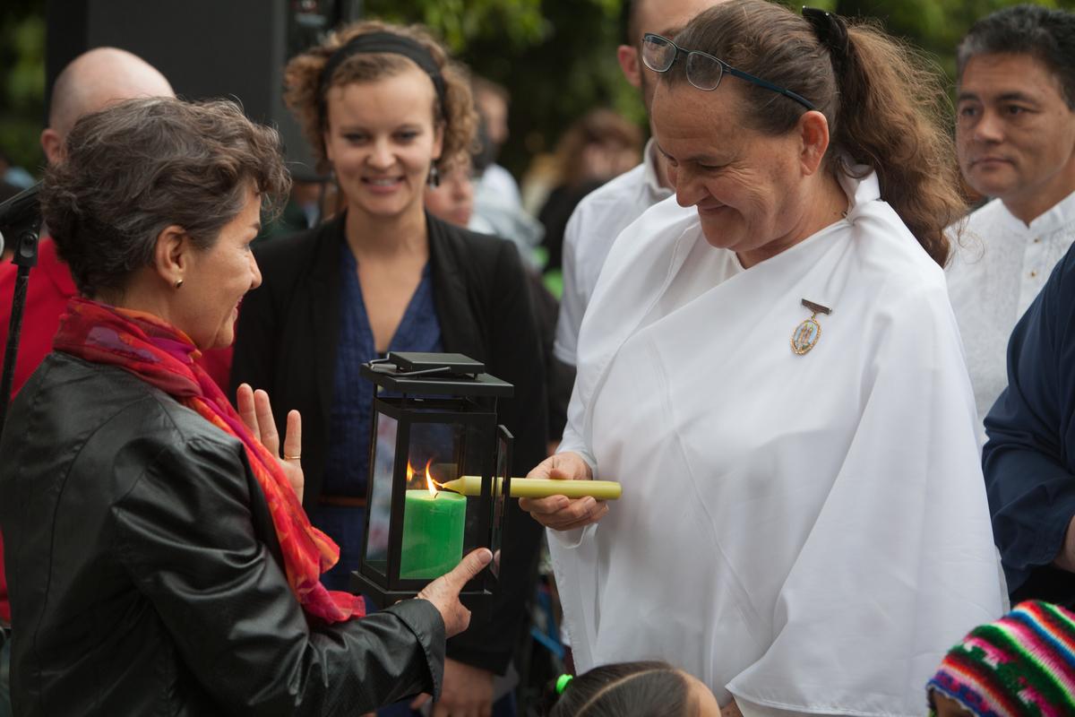 Christiana Figueres, UNFCC Exec. Secretary receiving the light during an Interfaith vigil, with Caroline Richter, LWF and faith members of Brahma Kuaris, LWF/Sean Hawkey