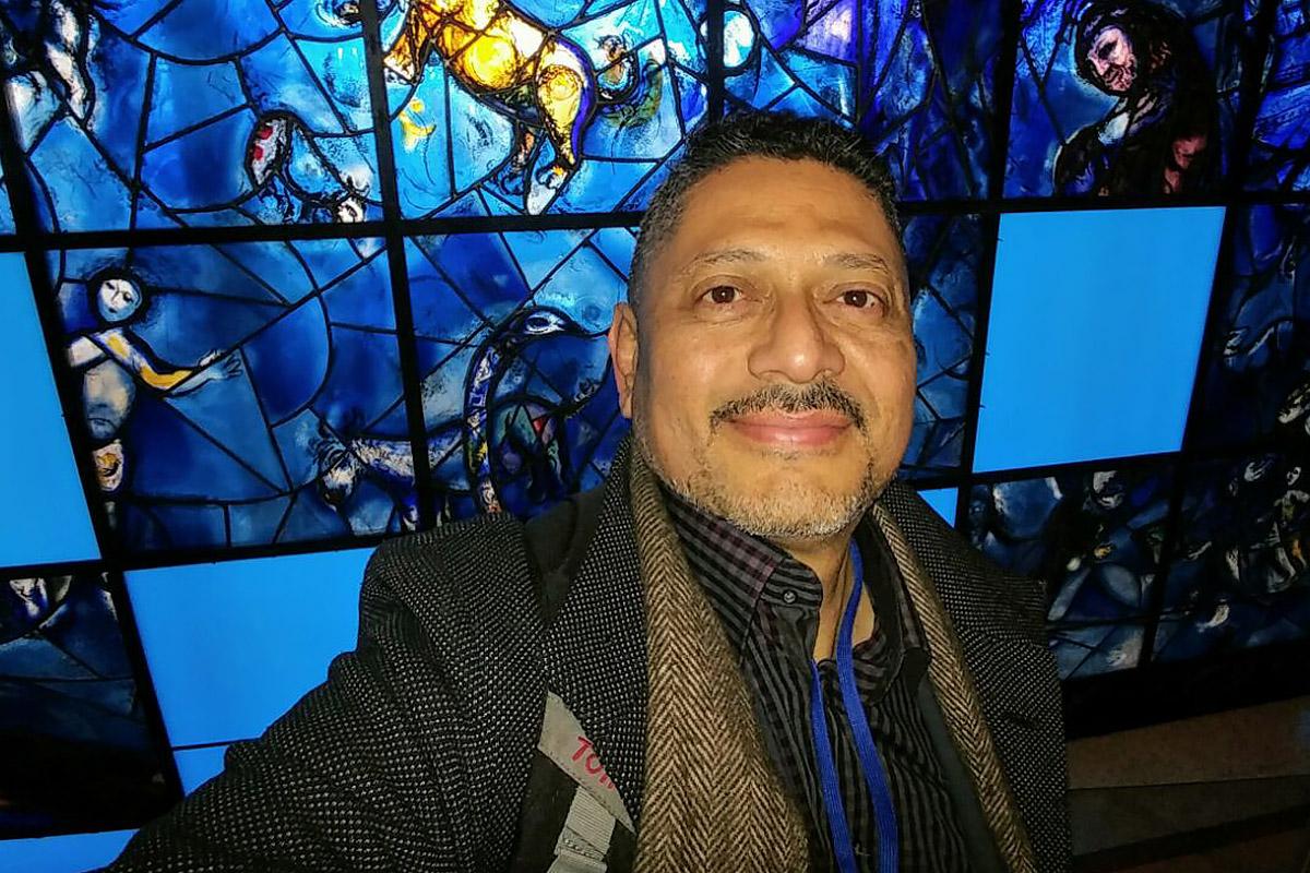 The people that walked in darkness have seen a great light: Larry Madrigal stands in front of the stained glass mural that inspired his mother at the 1994 CSW. Photo: L Madrigal