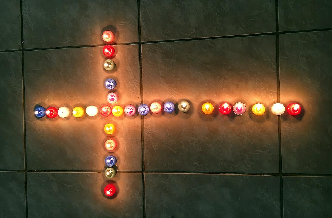 Candles lit in the shape of a cross to symbolize young adults as light in the world. Photo: LWF/C. Bader