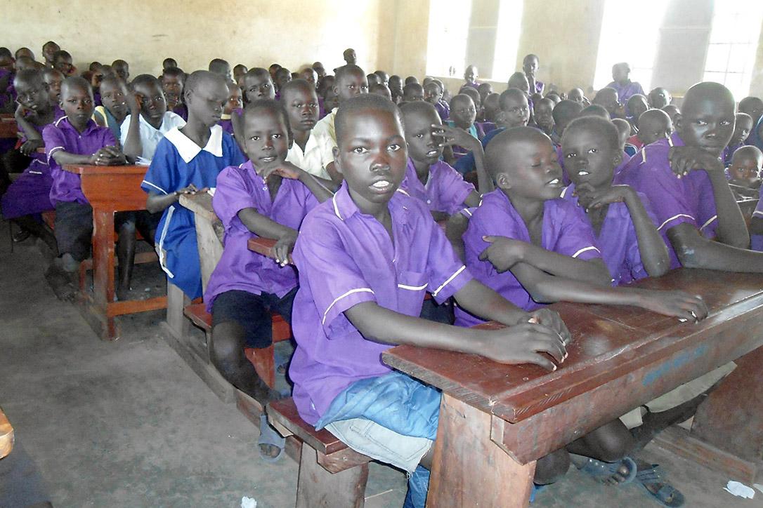 Emmanuel sits in class, supported by the LWF and safe from the violence he fled in South Sudan. Photo: LWF Uganda