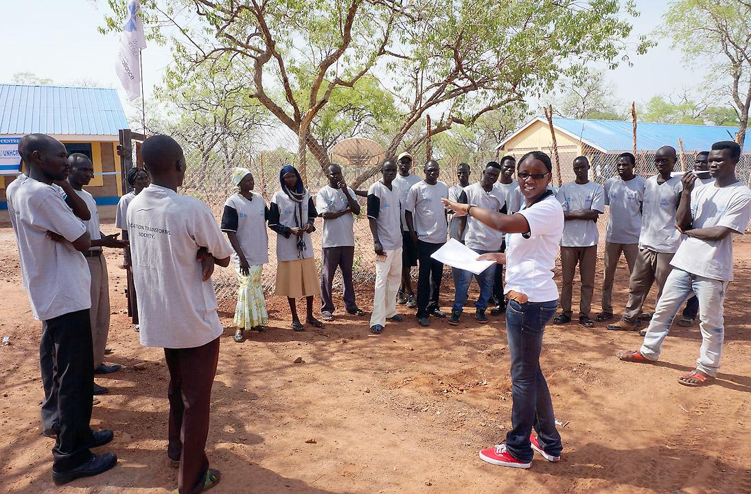 A staff members directs information and communications technology students outside the ICT centre in the Ajuongthok refugee camp where Anne Mwaura works. Photo: LWF/C. Mavenjina
