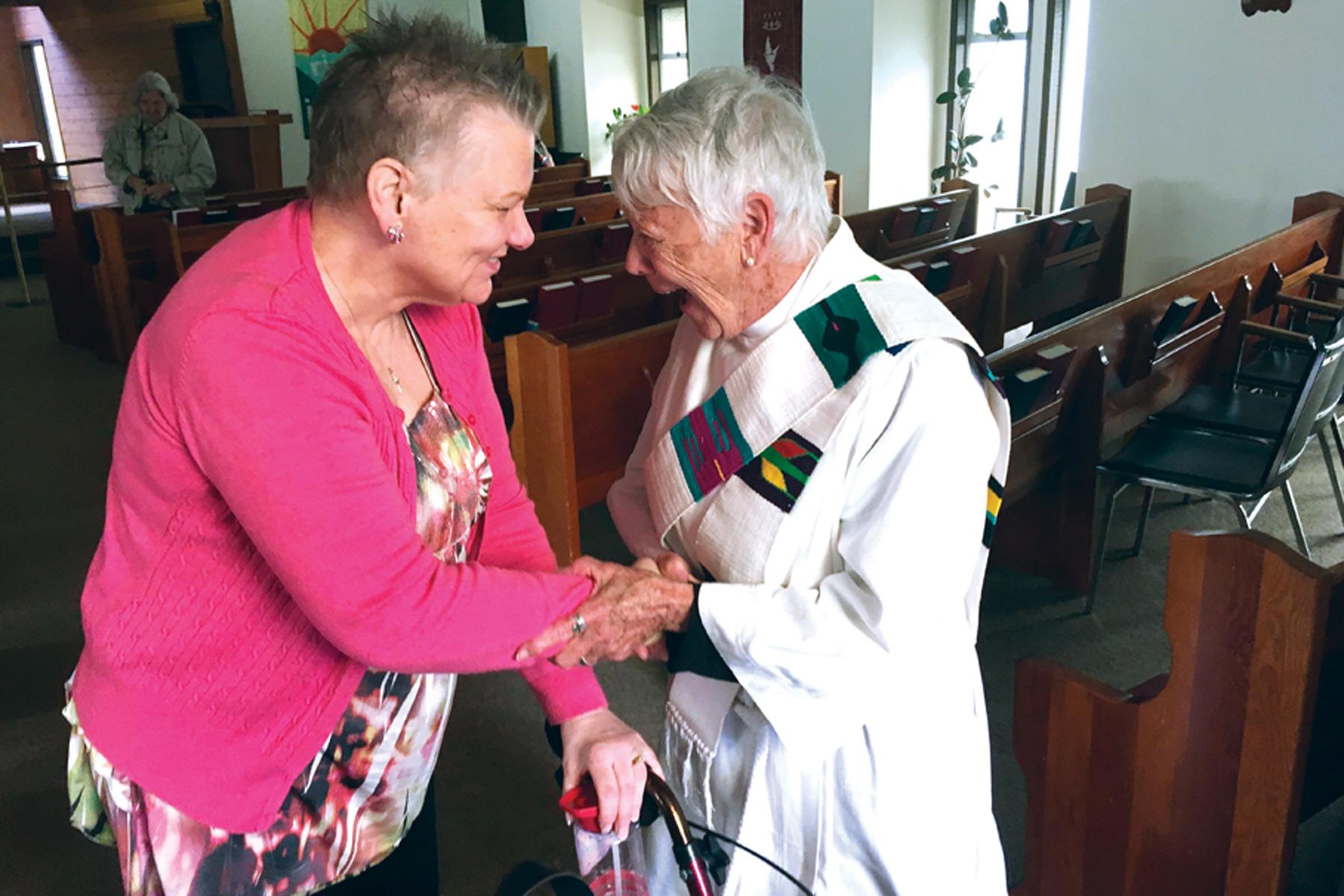 A minister greets a parishioner at the church at Faith, Province of British Columbia. Photo: Canada Lutheran