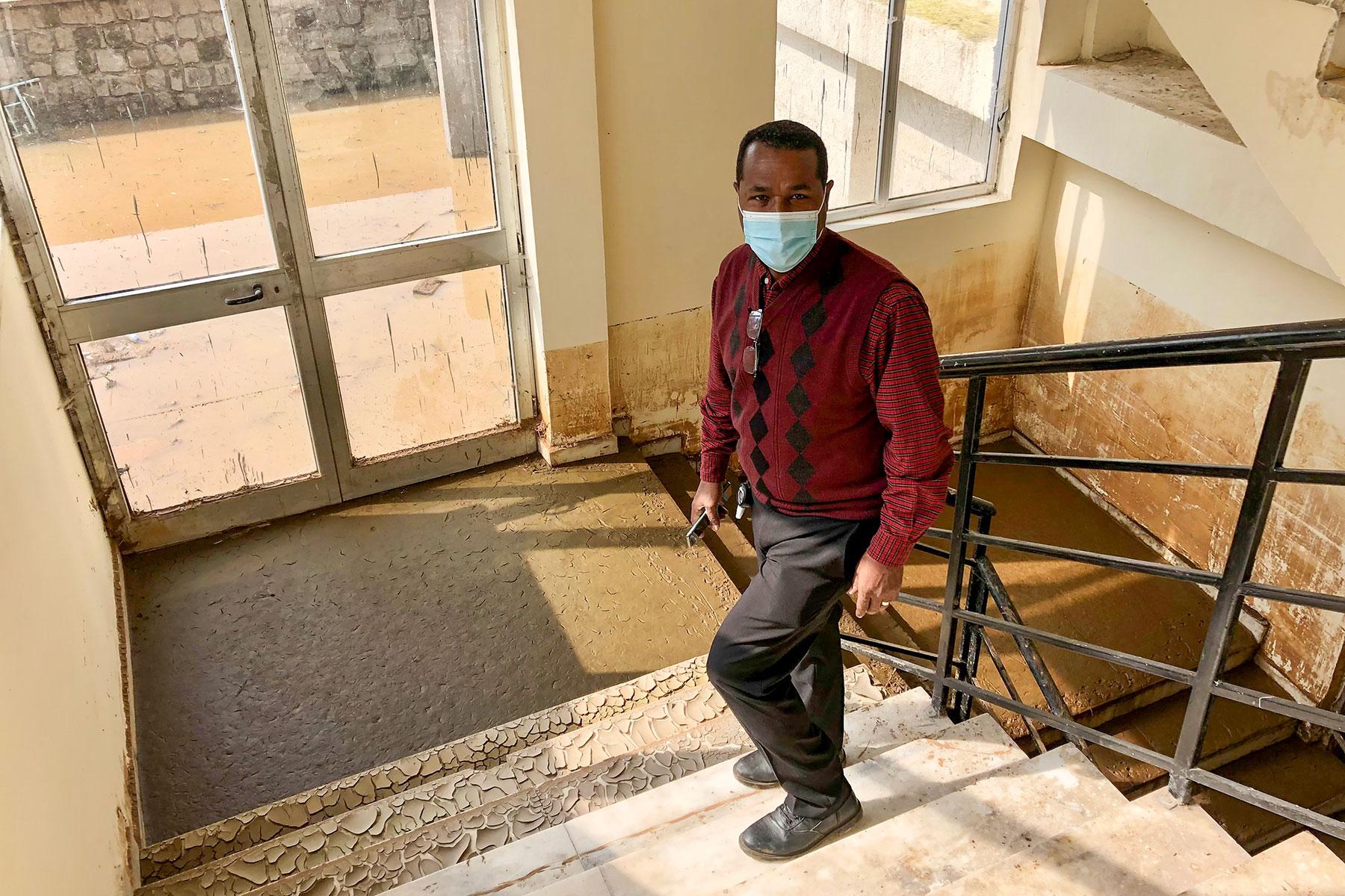 Rev. Dr Bruk Ayele Asale, president of the Mekane Yesus Seminary, on the ground level stairway to a dormitory floor. The walls bear the stained marks of the height that flooding waters had reached. All Photos: LWF/M. DÃ¶lker