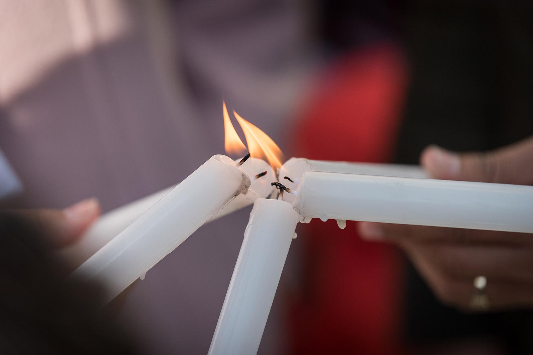 Lighting candles during a prayer at COP25 in Madrid, Spain. Photo: LWF/Albin Hillert