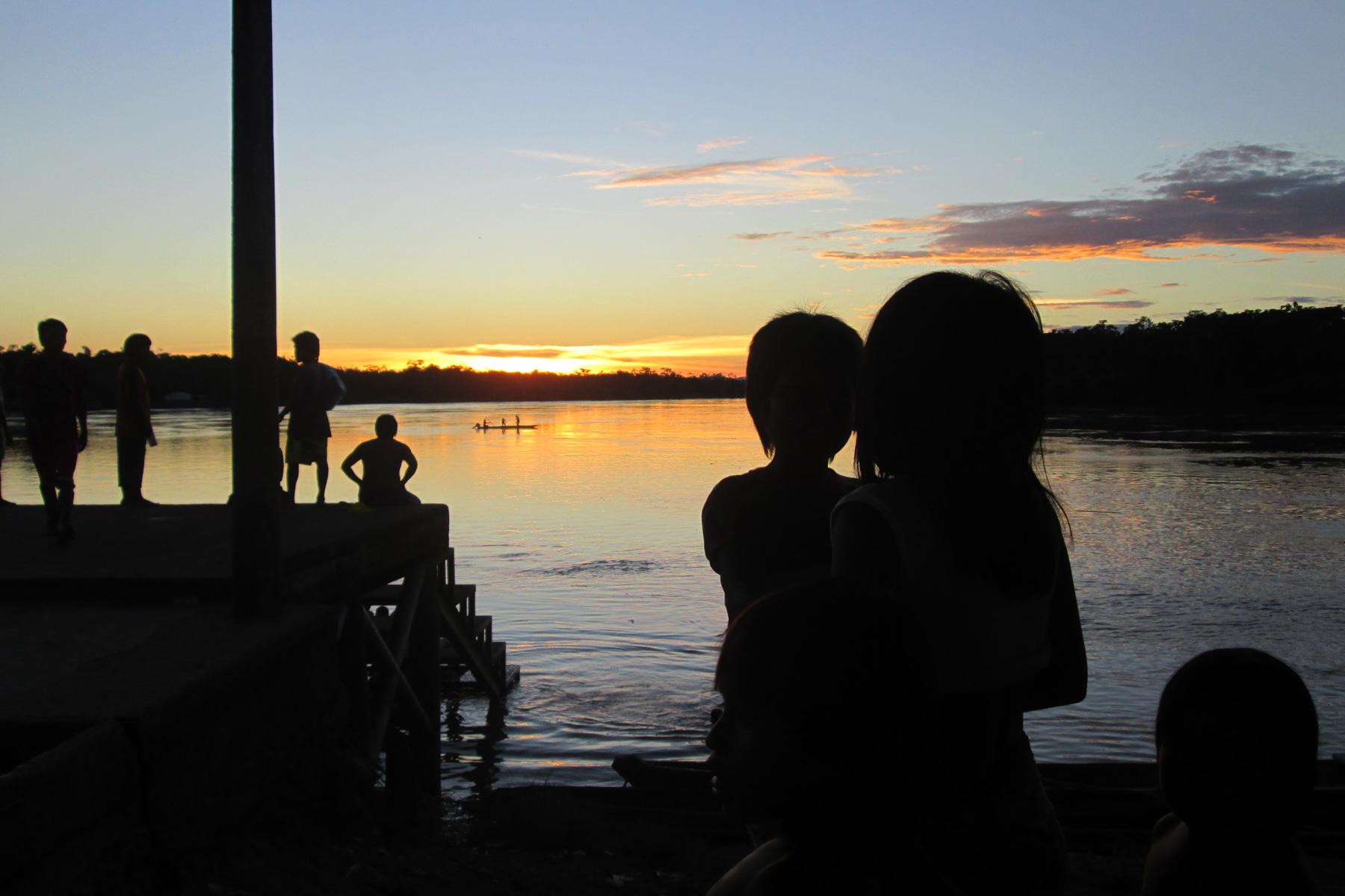 Children watch the sunrise at the Arauca river, Colombia. Photo: LWF