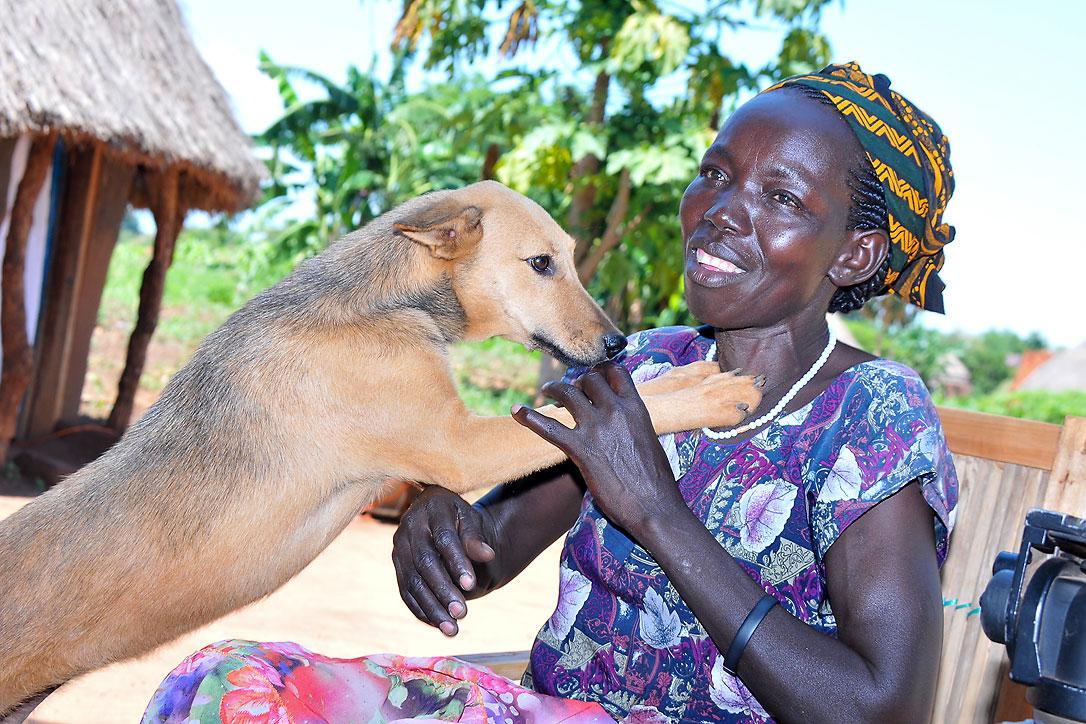 Molly Aringo with her dog. LWF has helped her embrace life again following a diagnosis of HIV. Photo: LWF/P. Kikomeko