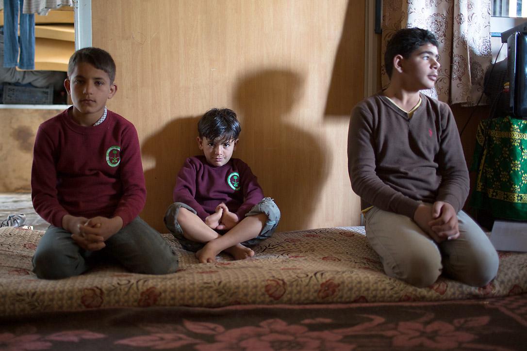 One half of all refugees at the Za'atari Camp are children. Three brothers from a Syrian family sit, hoping for an end to the conflict.  Photo: LWF/Maria de la Guardia 