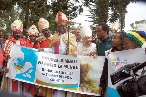 Bishop Younan (fourth from right) stands among Lutheran leaders welcoming a group of young Lutherans who climbed Mt Kilimanjaro. He told worshippers at the close of the Marangu conference that the challenge for Lutherans was to empower African Christians to more fully contextualize the gospel. Photo: LWF/Tsion Alemayehu
