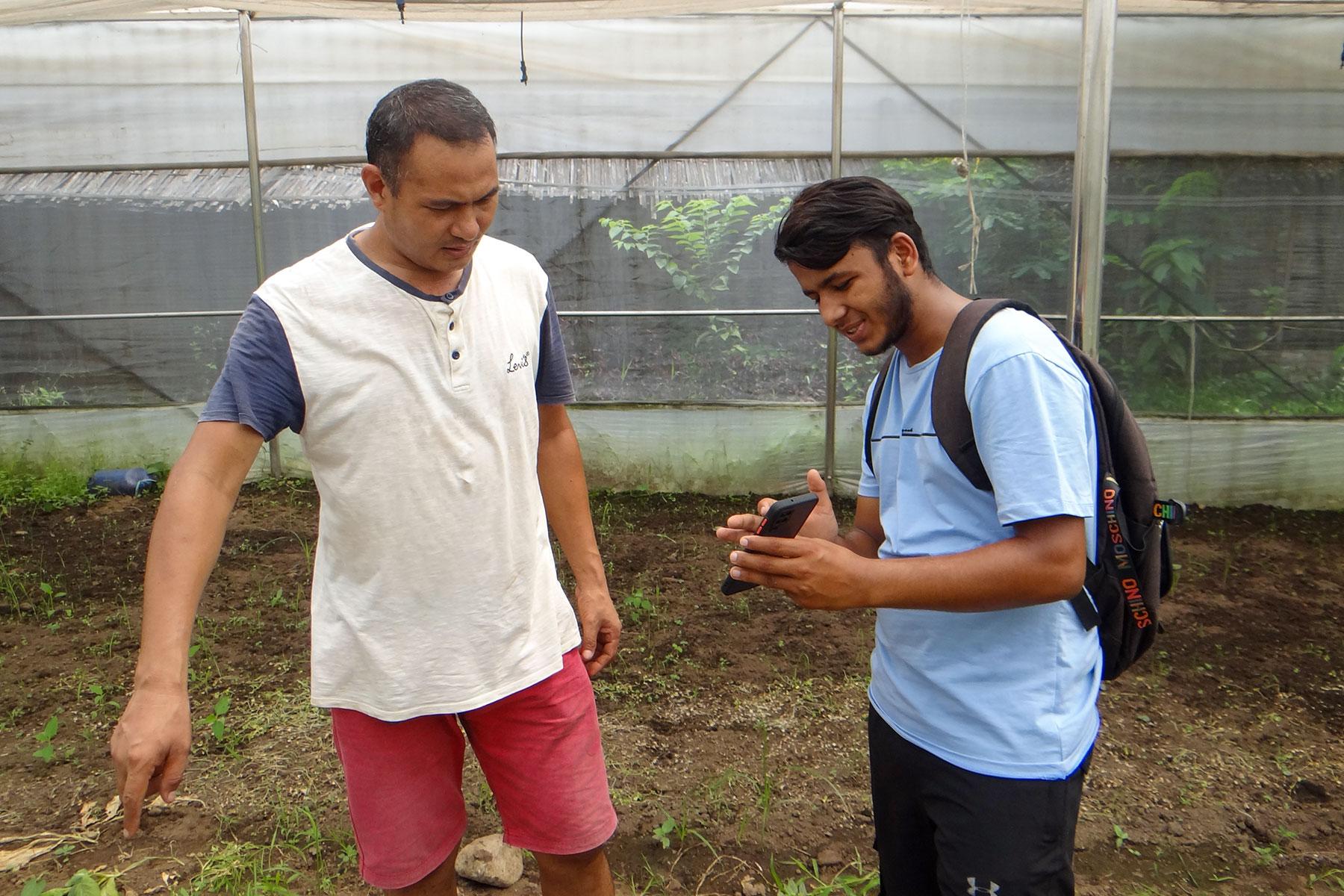 Anil, LWF Trainee, demonstrates features of the GeoKrishi app to local farmer in Nepal. Photo: LWF Nepal