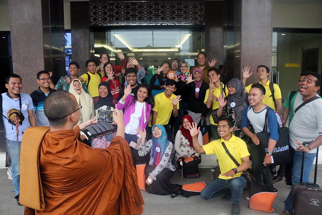 Monk Dhirapunno takes a group photo in front of the conference center in Medan. Photo: A. Yaqin