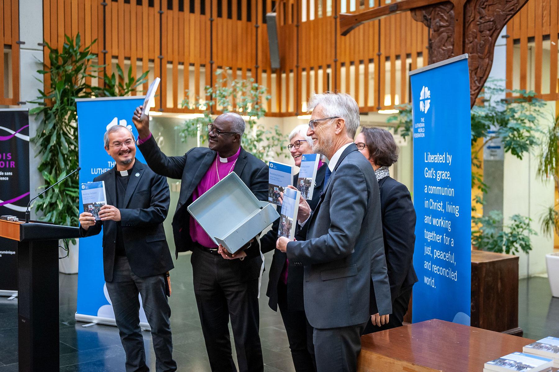 Unveiling the book. Left to right: Rev. Dr Sivin Kit, Archbishop Dr Panti Filibus Musa, Archbishop Dr Antje JackelÃ©n, Rev. Dr Martin Junge, and Rev. Dr Simone Sinn. Photo: LWF