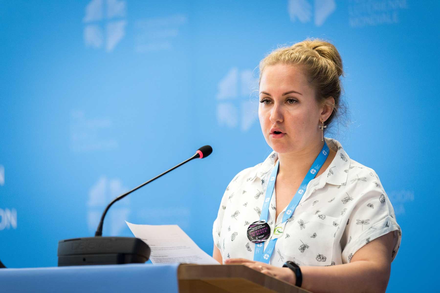 Ms Vera Tkach, chairperson of the Ad-hoc Committee for Advocacy and Public Voice, presents the resolution on Nigeria to the LWF council. Photo: LWF/ Albin Hillert