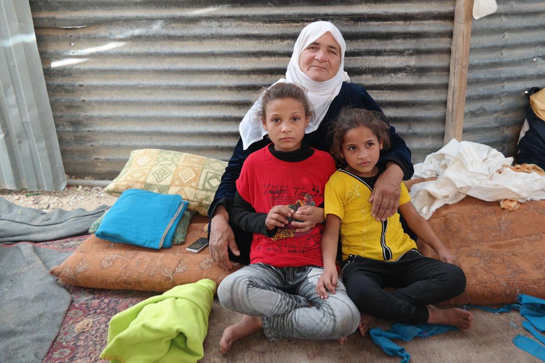 Salam (left, in red T-Shirt) with her grandmother and younger sister in their shelter in Zaâatari camp. Photo: LWF Jordan/D. OdÃ©n