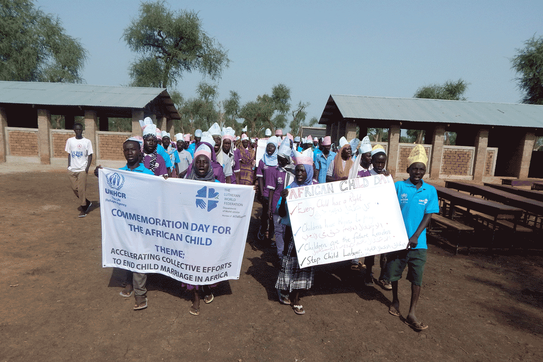 Dozens of school children march into Blue Nile Primary School protesting child marriage. Photo: LWF/J. Tiboa