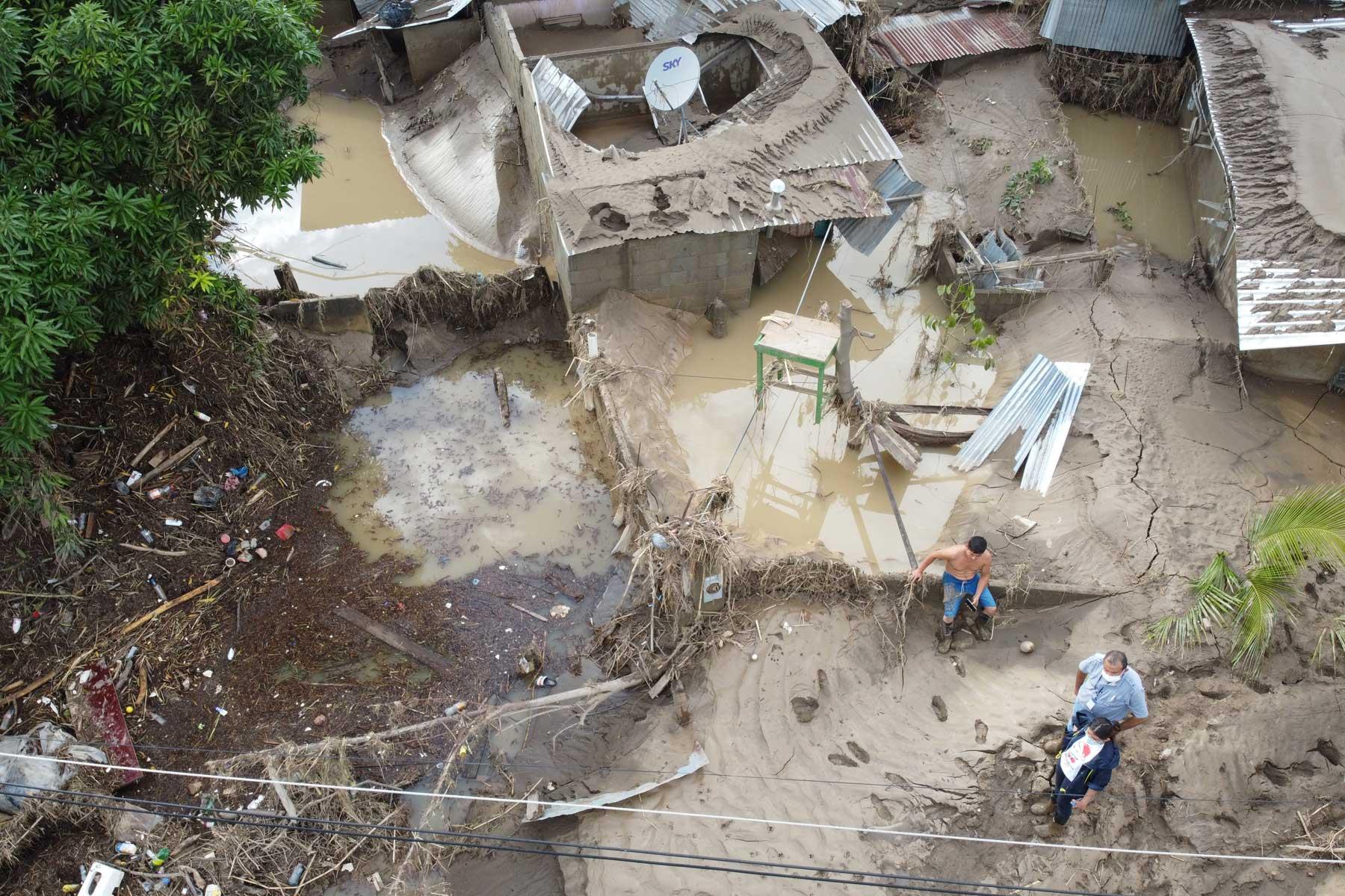 Extreme weather events: LWF representative Carlos Rivera (with white face mask) visiting ChamelecÃ³n, Honduras, where many homes were washed away in unexpected flooding from the hurricanes Eta and Iota in 2020. Photo: LWF/Sean Hawkey