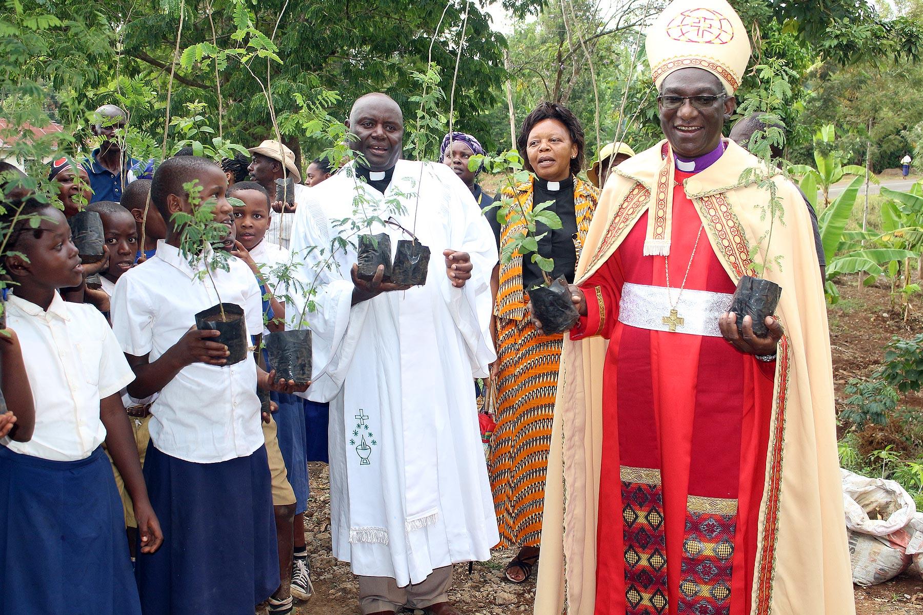 Planting trees has become part of church life in ELCT: (from the right) Bishop Fredrik Shoo, Rev. Faustine Kahwa, Rev. Solomon Massawe and students attending confirmation classes preparing for a tree planting in Tanzania's Northern Diocese. Photo: ELCT