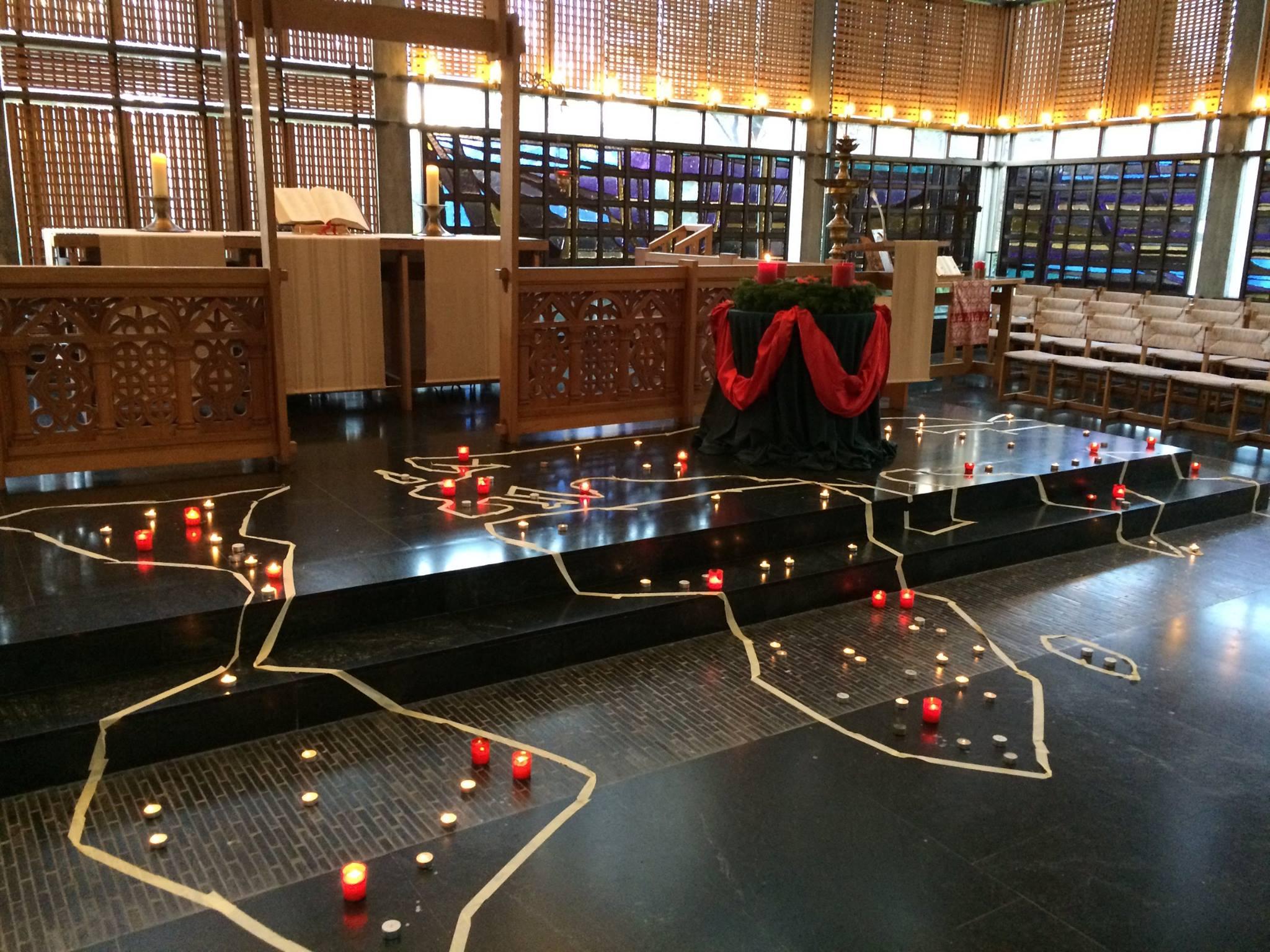 The outline of candle lit global map used to remember those affected by AIDS around the world.  Photo: LWF/P.Cuyatti