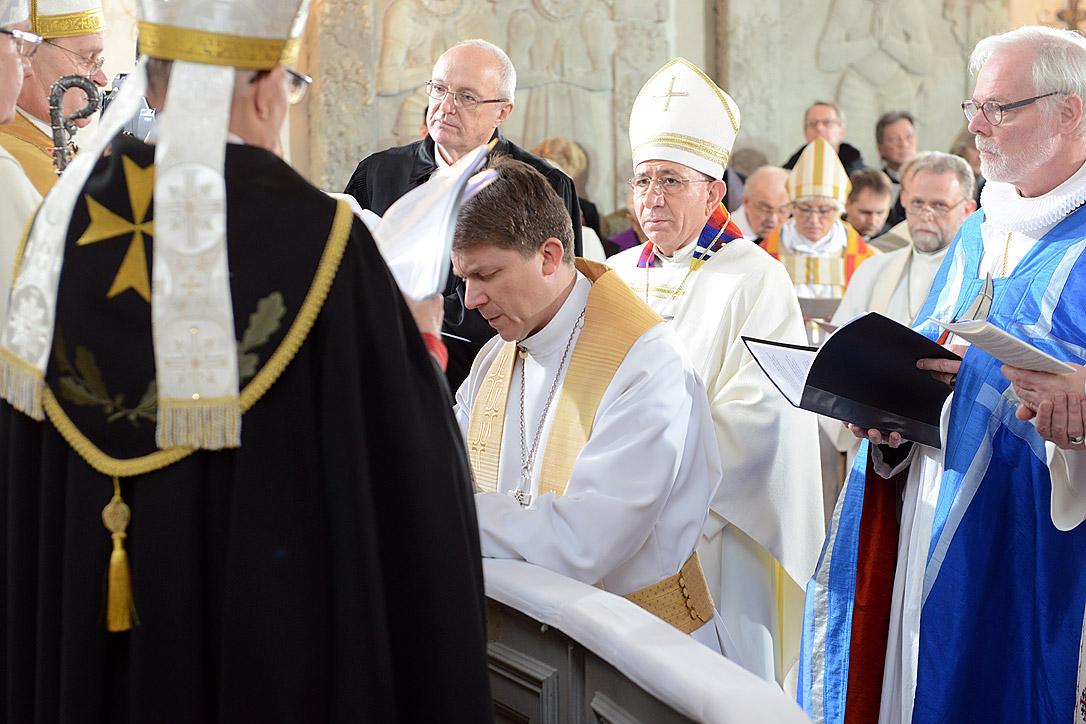 LWF President Bishop Dr Munib A. Younan and other church leaders during the consecration of Estonian Lutheran Archbishop Urmas Viilma (kneeling) at St Maryâs Cathedral in Tallinn. Photo: Erik Peinar