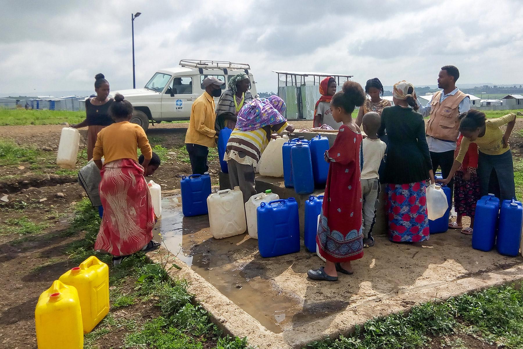 IDPs in Mekelle collecting water in Seba Kare IDP camp. LWF has constructed a water system in the camp, which was previously supplied with water by water trucking. Photo: LWF/ T. Debessu